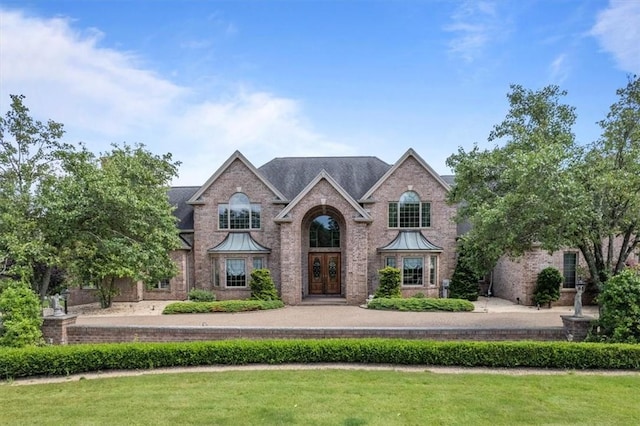 view of front facade featuring french doors and a front yard