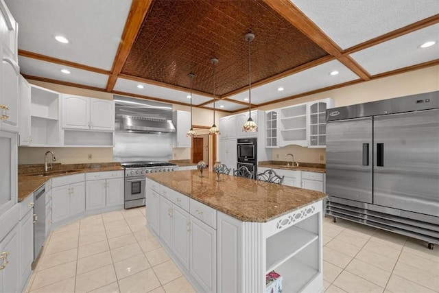 kitchen with a center island, sink, wall chimney exhaust hood, premium appliances, and white cabinetry