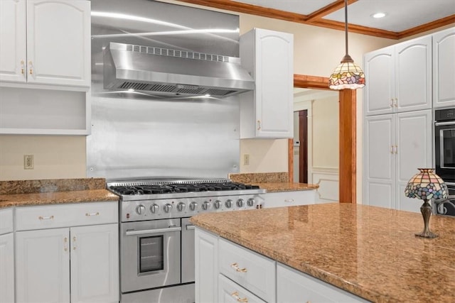 kitchen with wall chimney exhaust hood, light stone counters, high end stainless steel range, and white cabinets