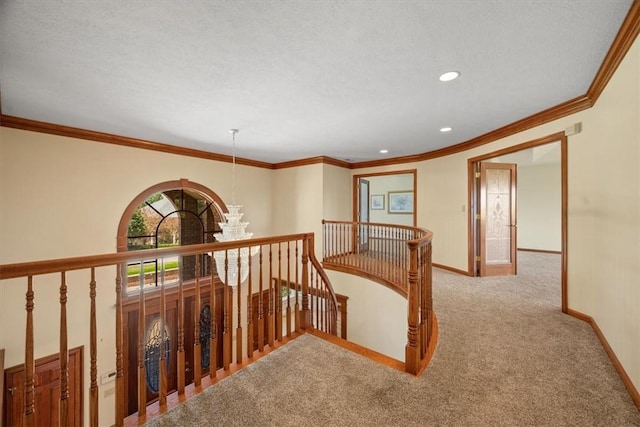 hallway with light carpet, an inviting chandelier, and crown molding