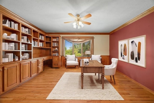 sitting room featuring a textured ceiling, ceiling fan, light hardwood / wood-style floors, and crown molding