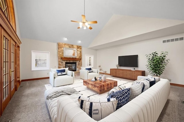 carpeted living room with ceiling fan, a fireplace, and high vaulted ceiling