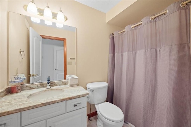 bathroom with vanity, toilet, and curtained shower