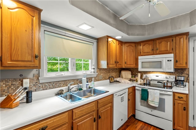 kitchen featuring dark hardwood / wood-style floors, ceiling fan, tasteful backsplash, sink, and white appliances