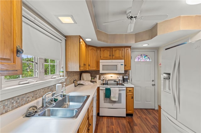 kitchen with backsplash, ceiling fan, dark wood-type flooring, sink, and white appliances