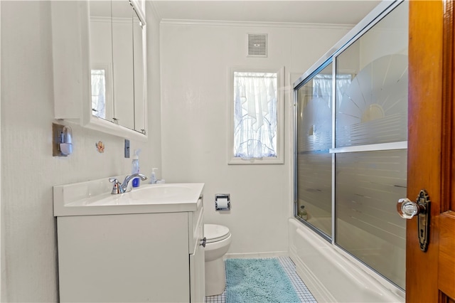 full bathroom with plenty of natural light, toilet, tile flooring, bath / shower combo with glass door, and vanity