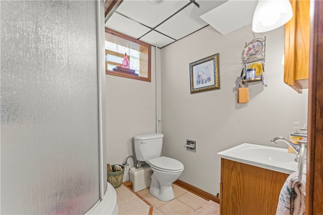 bathroom with tile floors, toilet, and vanity