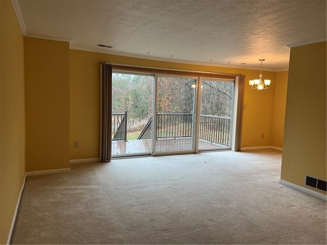 spare room with carpet, a textured ceiling, a chandelier, and crown molding