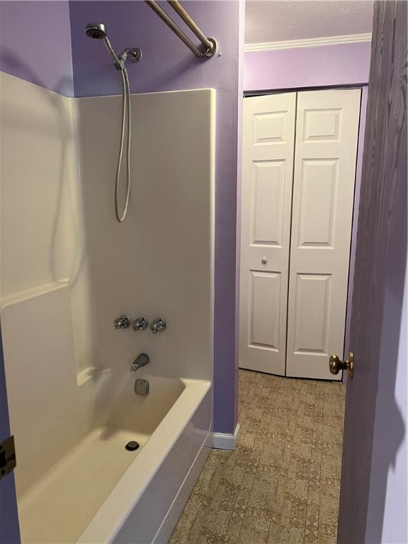 bathroom featuring ornamental molding and tub / shower combination