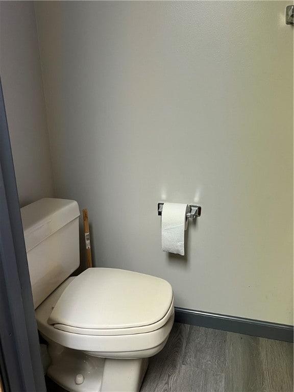 bathroom with hardwood / wood-style floors and toilet