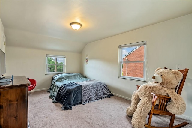 bedroom with vaulted ceiling and carpet