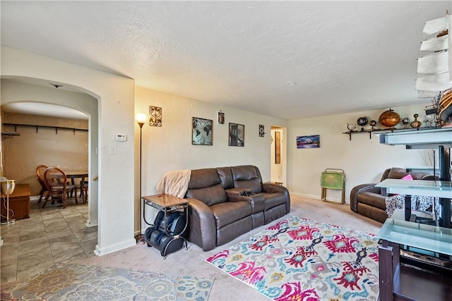 carpeted living room with a textured ceiling