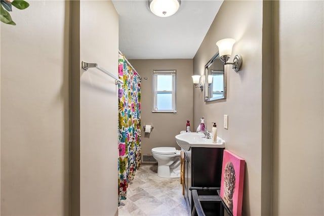 bathroom featuring toilet and vanity