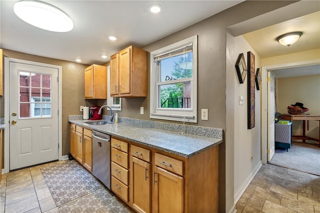 kitchen with sink, dishwasher, and light stone counters