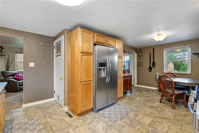 kitchen featuring stainless steel fridge with ice dispenser