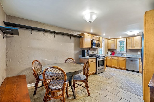 kitchen with sink, light brown cabinetry, and appliances with stainless steel finishes