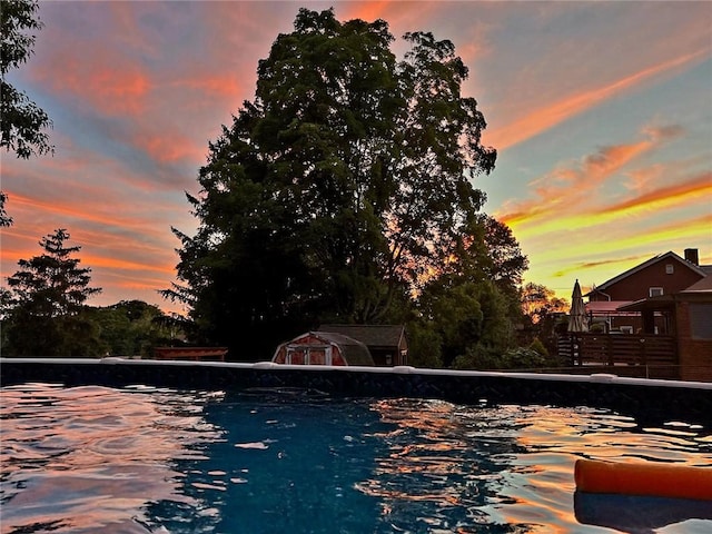 view of pool at dusk