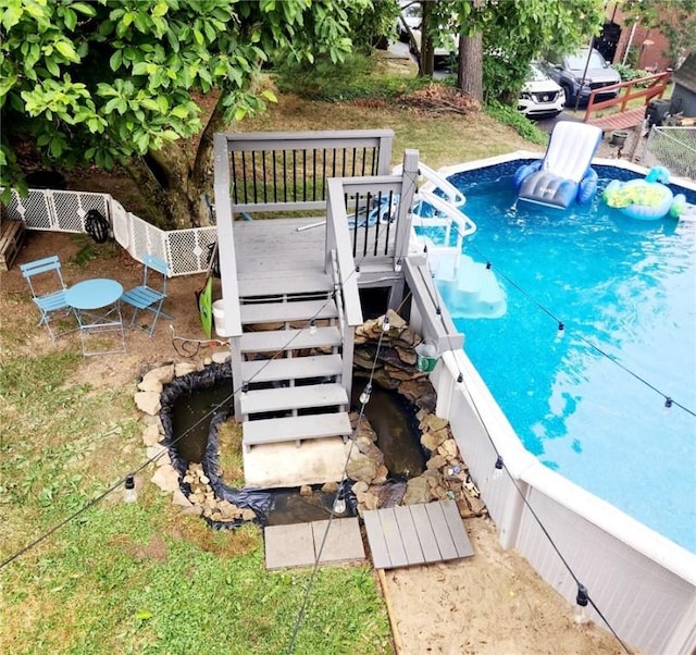 view of swimming pool featuring a wooden deck