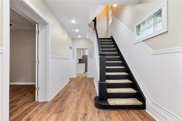 staircase with wood-type flooring