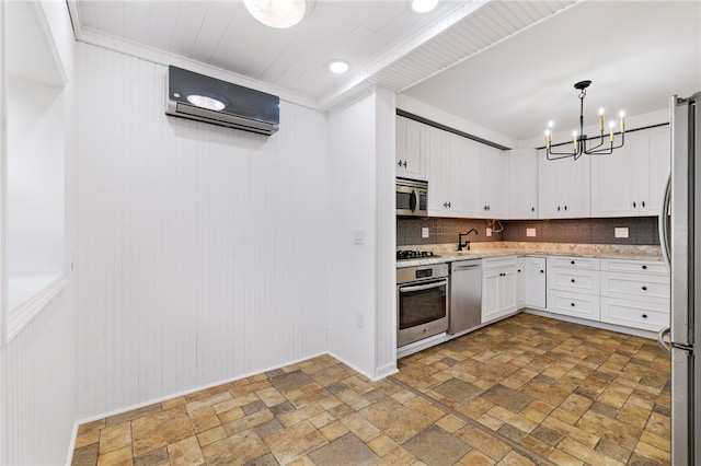 kitchen featuring stainless steel appliances, decorative light fixtures, backsplash, tile floors, and white cabinets