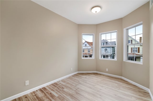 unfurnished room with plenty of natural light and light wood-type flooring