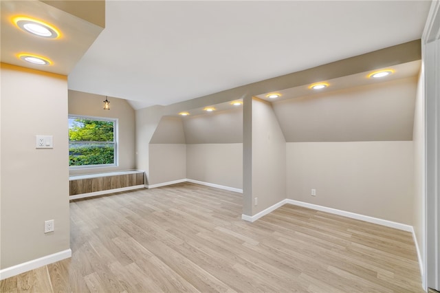 additional living space with lofted ceiling and light wood-type flooring