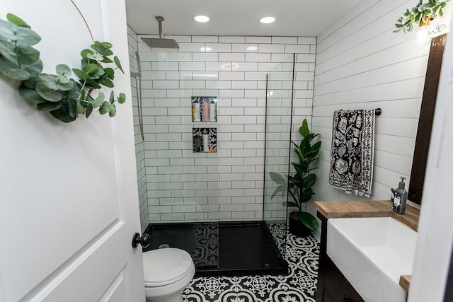 bathroom featuring tile flooring, toilet, and vanity