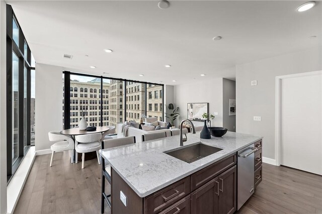 350 Oliver Ave Unit 1102, Downtown Pgh, PA 15222 - kitchen featuring a sink, wood finished floors, stainless steel dishwasher, dark brown cabinetry, and recessed lighting