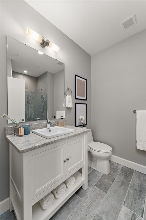 bathroom featuring toilet and vanity with extensive cabinet space