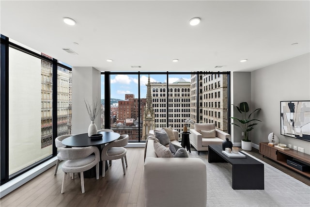 living room featuring hardwood / wood-style flooring and a wall of windows