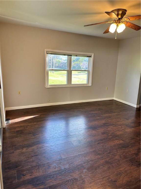 unfurnished room with ceiling fan and dark wood-type flooring