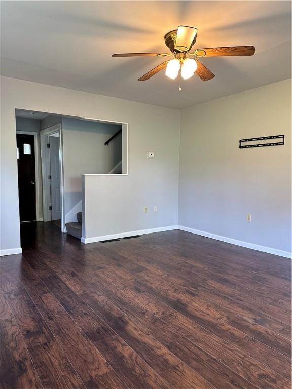 spare room with ceiling fan and dark hardwood / wood-style flooring