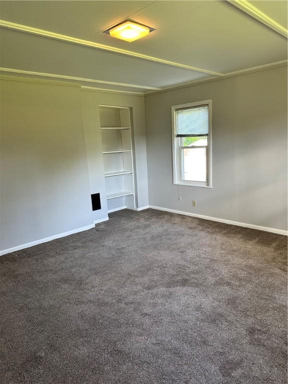 carpeted spare room with built in features