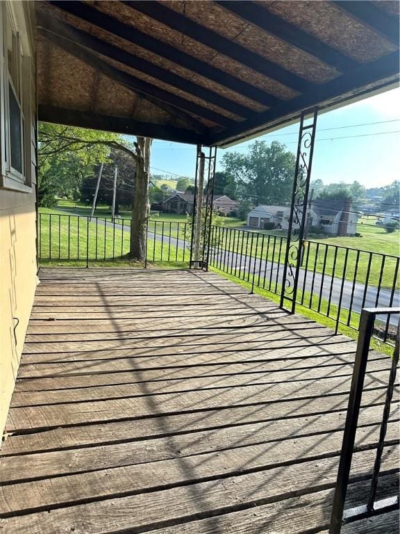 wooden terrace with a lawn