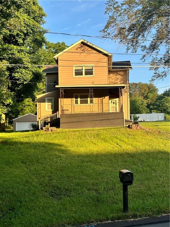 view of front of property with a porch and a front lawn