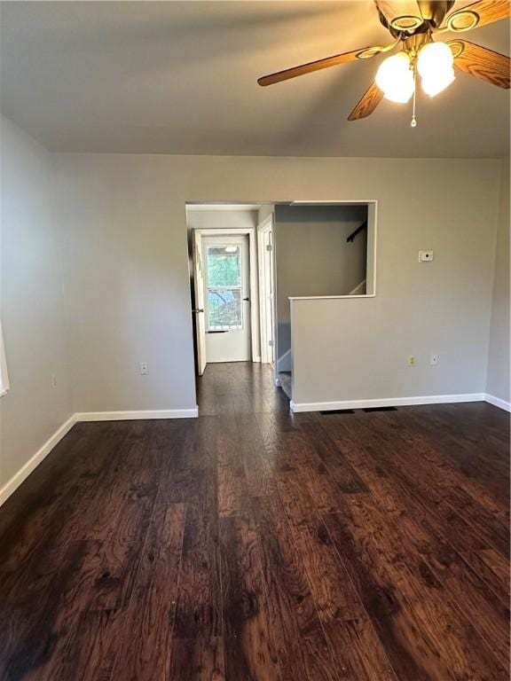 unfurnished room with dark hardwood / wood-style flooring and ceiling fan