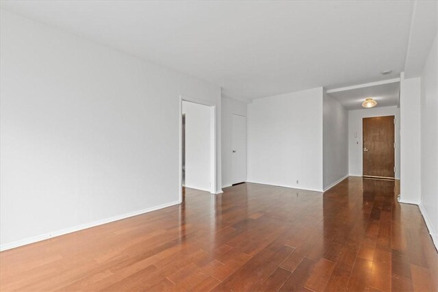 spare room featuring wood-type flooring