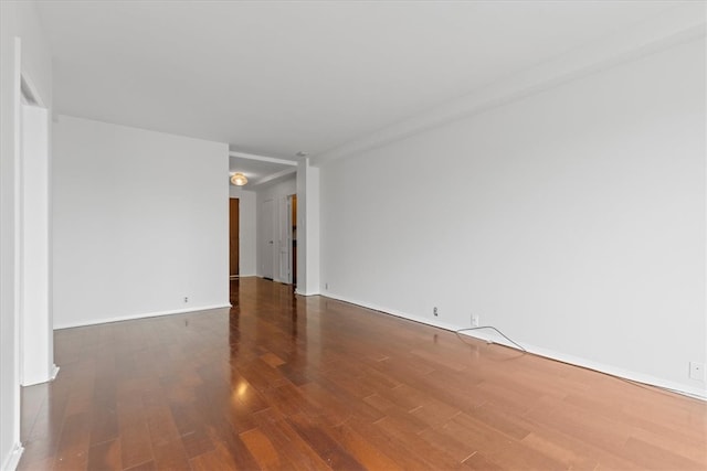 unfurnished room featuring dark wood-type flooring