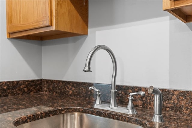 interior details with dark stone countertops and sink