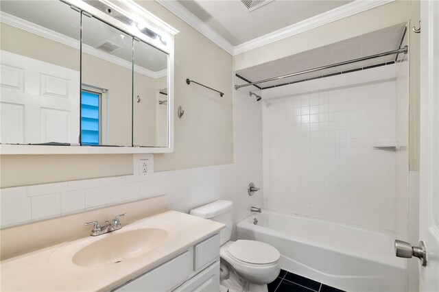 full bathroom with tile walls, toilet, tiled shower / bath combo, tile flooring, and large vanity