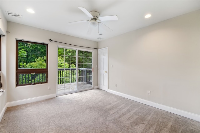 spare room featuring carpet and ceiling fan