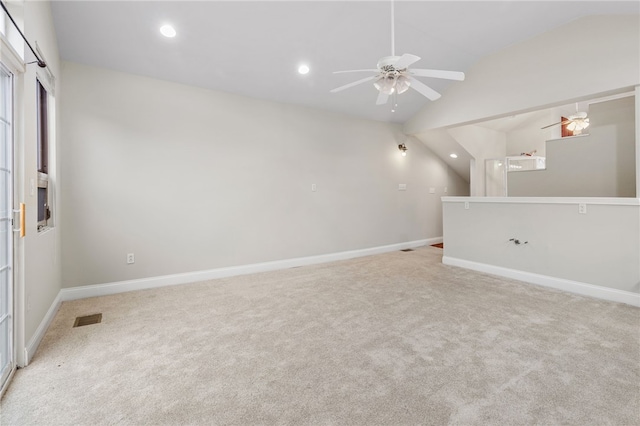 interior space featuring lofted ceiling, ceiling fan, and light colored carpet