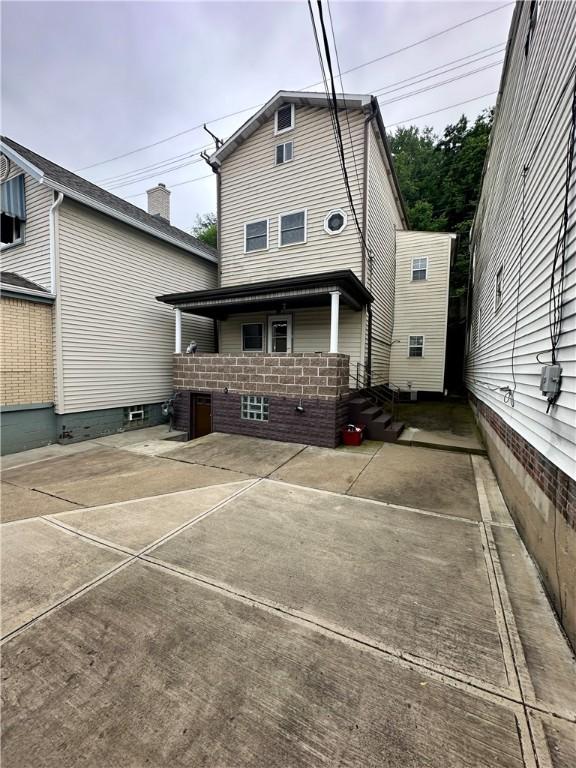 rear view of property featuring a patio area