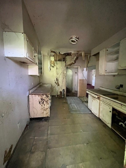 kitchen featuring tile flooring and white cabinetry