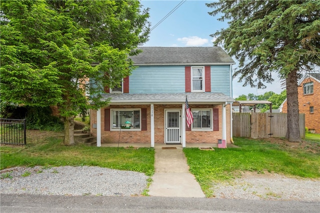 view of front of house featuring a porch and a front yard