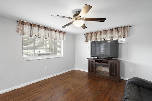 living room featuring dark hardwood / wood-style flooring and ceiling fan