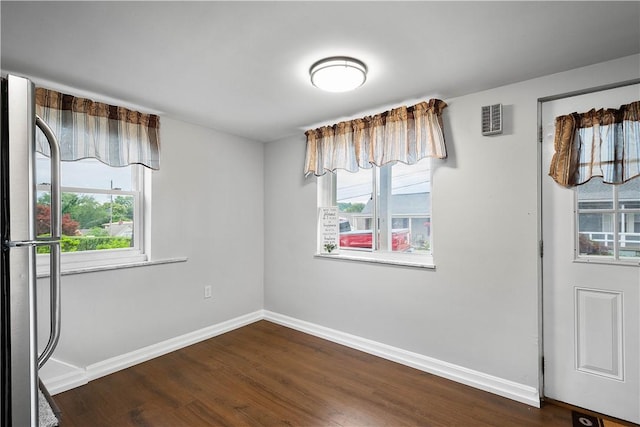 unfurnished room with dark hardwood / wood-style flooring