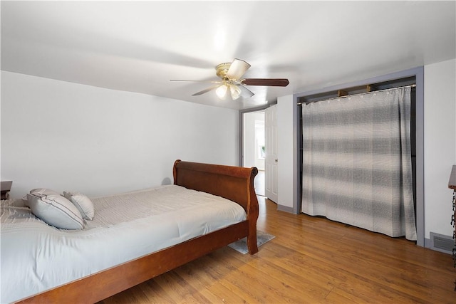 bedroom with ceiling fan and wood-type flooring