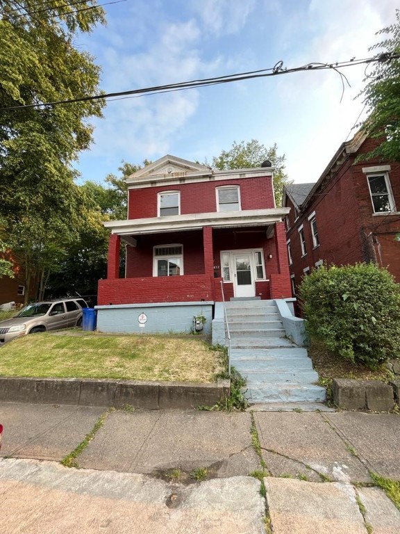 view of front of property with a porch and a front yard