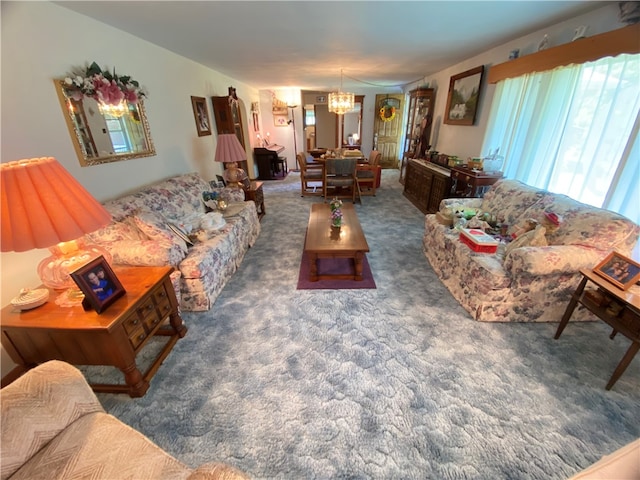 living room featuring a chandelier and dark carpet